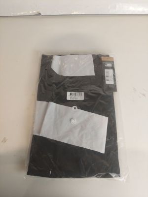une chemise noire et blanche posée sur une table blanche