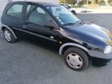 a picture of a small black car parked in a parking lot