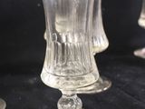 three clear glass goblets sitting on top of a black table