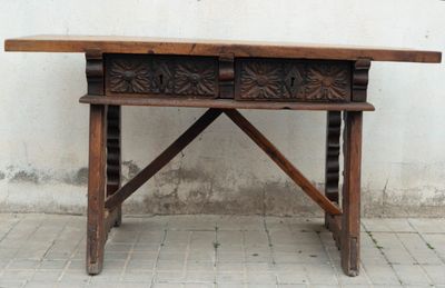 a wooden table with two drawers on top of it