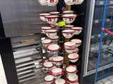 many bowls and pans stacked on a rack in a store
