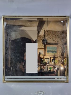 a reflection of a person in a mirror on the wall