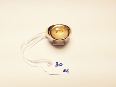 a small metal object with a tag attached to it