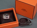 an orange box with a silver ring inside of it on a table
