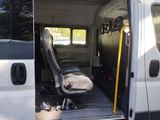a white van with the door open and a seat in the back