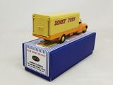 yellow and orange toy truck sitting on top of a blue box