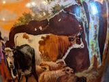 a vase with a picture of a herd of cattle on it