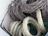 a bucket full of different types of rope in it