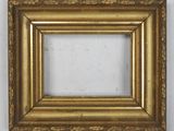 a gold picture frame on a wall with a white background