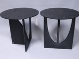 pair of black side tables with curved legs on a white background