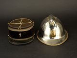 pair of silver plated hats with black and gold trims