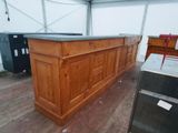 un bar en bois avec un comptoir noir dans une pièce