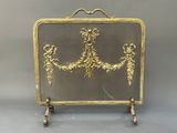 an image of a gold plated fireplace screen with flowers on it