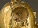 a gold helmet with a face on it on a table