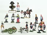 many figurines of soldiers on display on a white surface