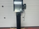 an image of a television on a stand in front of a garage