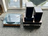 two speakers and a record player sitting on the floor