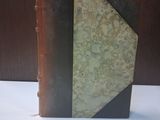 a book that is sitting on a table next to a wall