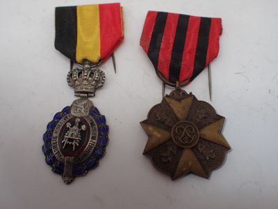 two medals and a medal on a white surface