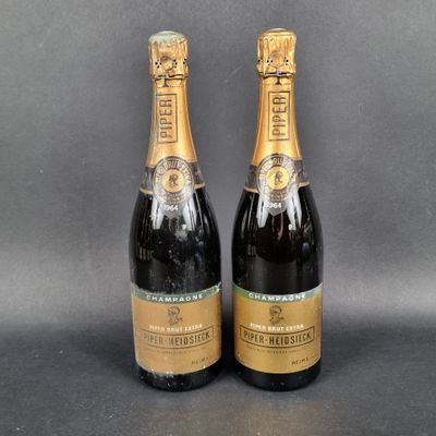 two bottles of champagne sitting next to each other on a table