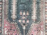 an antique rug with a blue background and a pink border