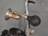 a close up of a motorcycle with a bell on it ' s handlebars