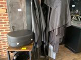 an image of a room with a bunch of clothes hanging on a rack