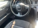 dashboard view of a car with a steering wheel and dashboard controls
