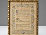 a gold frame with a poem written in it on a table