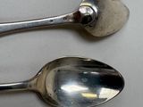 two spoons and a fork on a table