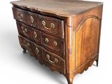 an image of a wooden chest of drawers with brass handles
