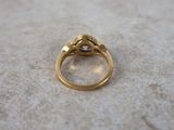 a close up of a gold ring with a diamond on it