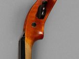a close up of a violin on a gray surface
