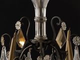 a chandelier made of glass and metal on a black background