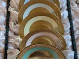 a lot of gold and blue plates in a box