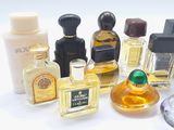 many different types of perfume bottles on a white surface