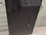 an image of a black refrigerator in a bathroom