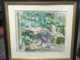 framed watercolor painting of a man sitting at a table in a garden
