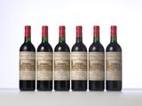 four bottles of red wine lined up in a row