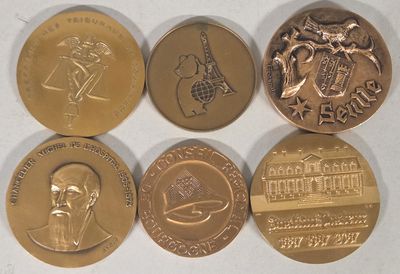 four different types of coins are shown on a white surface