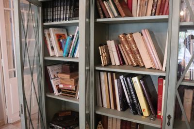 many books that are on the shelves in the room