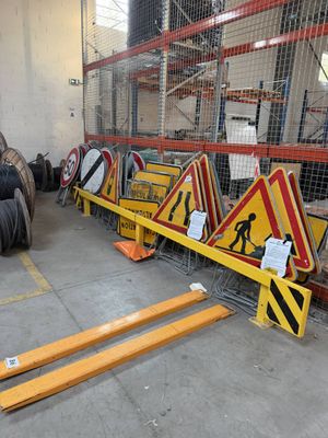 many signs and signs on the floor of a warehouse