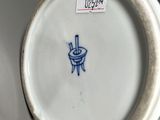a white plate with a blue design on it