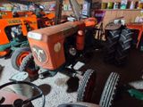 a tractor and other farm equipment in a garage