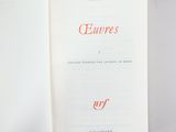 an open book with red writing on it sitting on a table
