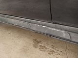 a car that has been painted black and is parked in a garage