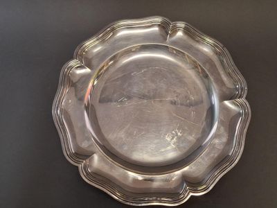 a silver plate that is on a black table