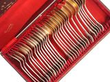 silverware in a red box on a white surface with a red cloth
