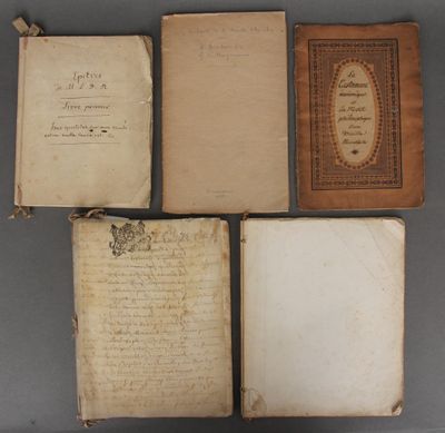 four old books are lined up on top of each other
