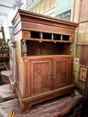 a wooden cabinet that is sitting on top of a pile of boxes
